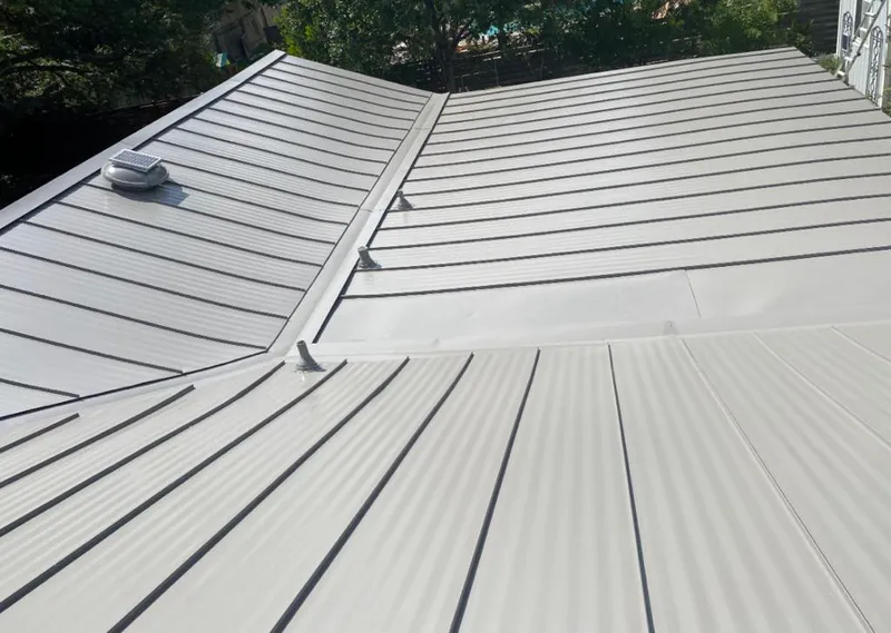 Solar attic fan installed on a metal roof for Roof Ventilation in Woodcrest